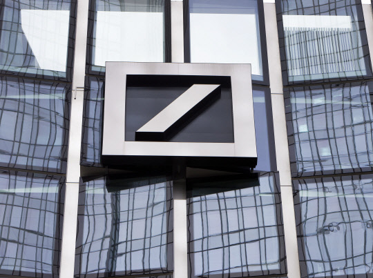 FILE - The Deutsche Bank logo is displayed at a bank's building in Frankfurt, Germany, April 9, 2018. Shares in Deutsche Bank, Germany's largest lender, have fallen sharply and dragged down major European banks as fears about weaknesses in the global financial system send fresh shudders through the markets. Deutsche Bank shares were off more than 12% in midday trading in Frankfurt on Friday, March 24, 2023. (AP Photo/Michael Probst, File) FILE PHOTO